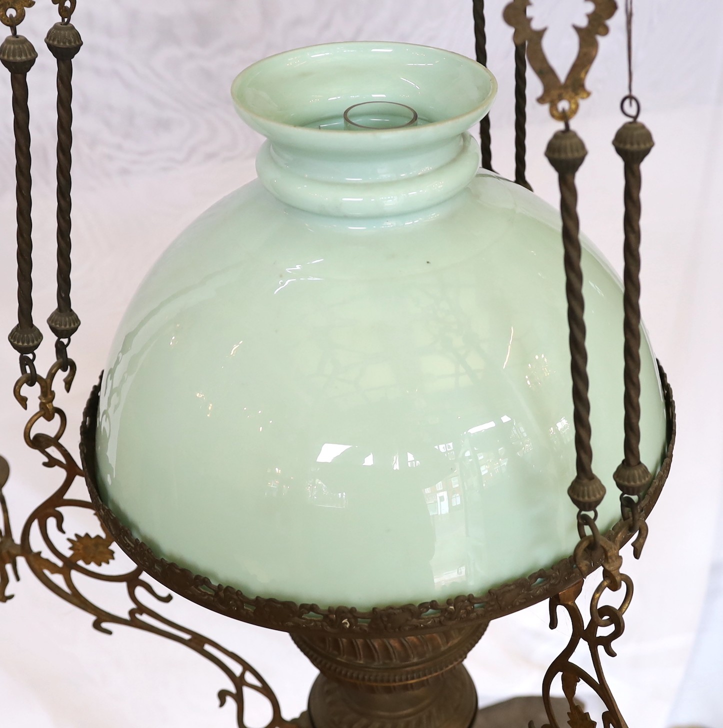 A Victorian brass counterbalanced hanging oil lamp with opaque blue glass shades and six candle sconces to the arms, height 136cm